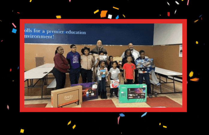 student winners posing with their prizes and Brewer staff and principal